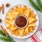 Air fryer tortilla chips coated with cinnamon sugar, served with chocolate dip and festive garnishes.